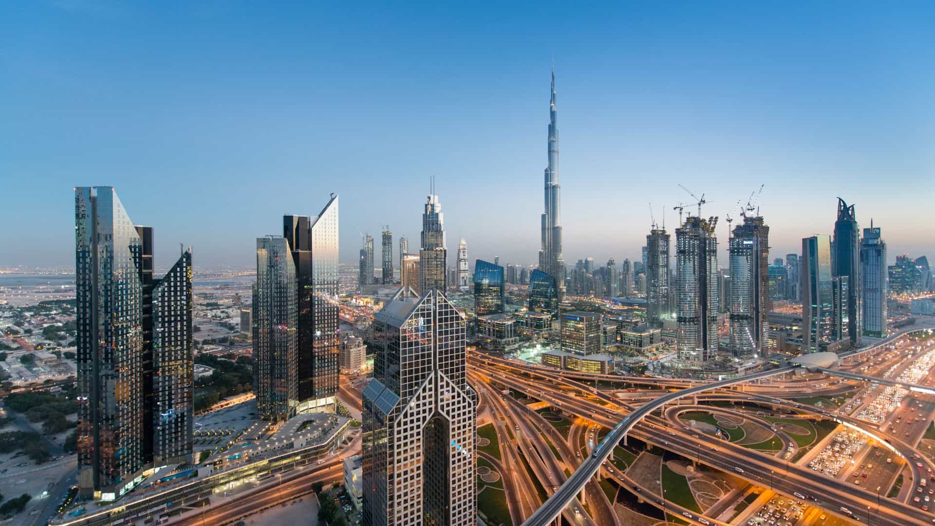 Dubai skyline and highway interchange at dusk, representing GCC financial institutions and large-scale portfolio exposure.